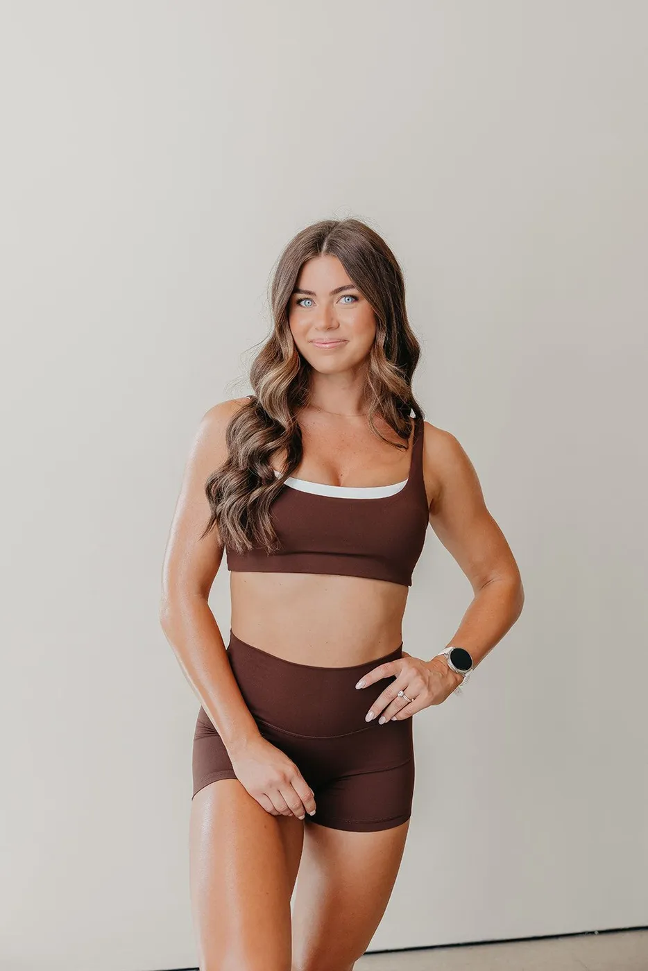 Jens in a chocolate sports bra and shorts in the studio